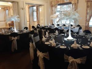 a room with long tables with bows on them at The Hind Hotel in Wellingborough