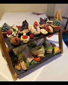 a tray of different types of desserts on a table at The Hind Hotel in Wellingborough
