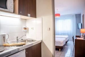 Postel nebo postele na pokoji v ubytování Comfort Aparthotel Besancon La City