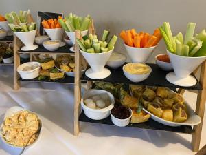 a set of three shelves filled with different types of food at The Hind Hotel in Wellingborough