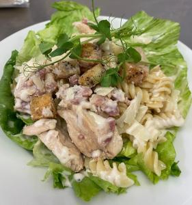 a plate of food with chicken pasta and lettuce at The Hind Hotel in Wellingborough
