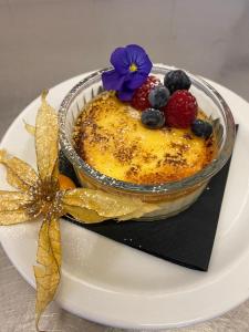 a dessert with fruit on a plate on a table at The Hind Hotel in Wellingborough