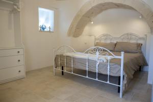 a bedroom with a white bed in a room at Masseria Comara in Monopoli +62 photos