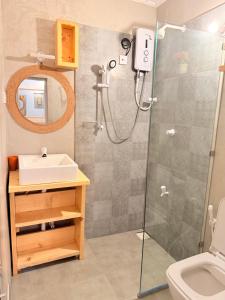a bathroom with a shower and a sink at Sun Shine Guest House in Negombo +34 photos