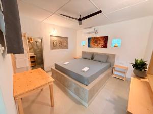 a small bedroom with a bed and a table at Sun Shine Guest House in Negombo
