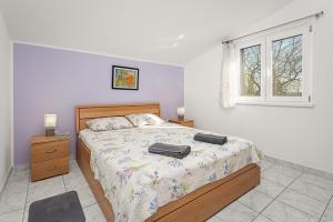 a bedroom with a bed with two bags on it at Regina 1 in Banjole
