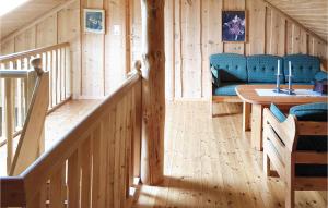 a wooden room with a table and a blue couch at Hytte Nr 4-156 in Frafjord
