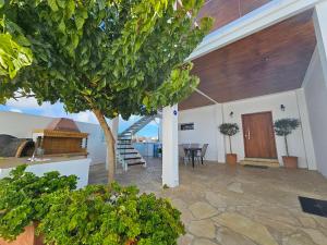 a living room with a tree and a staircase in a house at Villa Anthitsa in Paphos