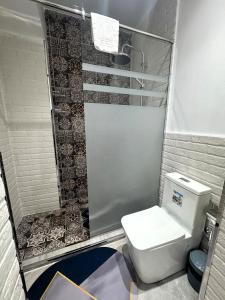 a small bathroom with a toilet and a shower at Zimmer Boutique Hotel in Baku