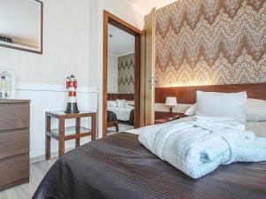 a bedroom with a large bed and a mirror at Holiday Beach Budapest Wellness Hotel with Sauna Park in Budapest