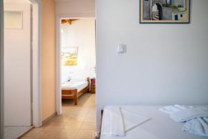 a room with a bed and a room with a bedroom at Elli Studios & Apartments in Marathokampos