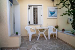 a white table and chairs on a patio at Elli Studios & Apartments in Marathokampos