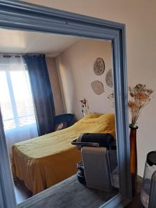 Un reflejo en el espejo de una cama en un dormitorio. en chambre cosy en centre ville avec accès indépendant, en Châtellerault 7 fotos más