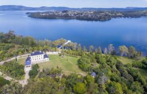 an aerial view of a house on a island in a lake at Chateau Le Marais in Wallis Island
