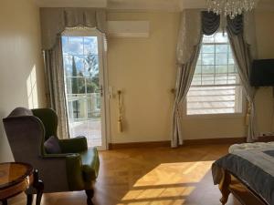 a bedroom with a bed and a chair and a window at Chateau Le Marais in Wallis Island