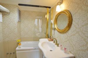 a bathroom with a sink and a mirror and a tub at By Murat Royal Hotel Galata in Istanbul +25 photos