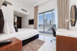 Postel nebo postele na pokoji v ubytování Hotel Avalon Dubai Jumeirah Village Circle
