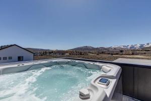 a hot tub with a view of the mountains at 6-Bedroom House, Sleeps 25, Tesla Friendly, New Build Near PCMR, Rooftop Spa in Park City