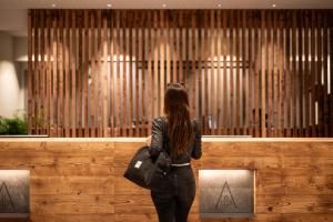 a woman standing in front of a organ at ADEA Lifestyle Suites Fieberbrunn in Fieberbrunn +148 photos