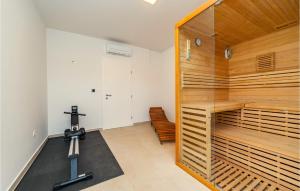 a room with a gym with a treadmill and a mirror at Villa Tala in Mrljane