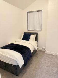 a bedroom with a bed with a black and white comforter at Cozy 3-Bedroom Home Perfect for Work & Leisure in Birmingham +1 photo