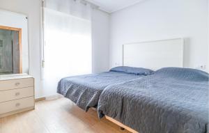 a bedroom with a bed and a dresser and a window at Awesome Home In San Juan De Los Terrer in San Juan de los Terreros