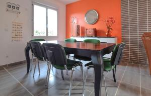 a dining room with a table and green chairs at Beautiful Home In Auberville With Wifi in Auberville