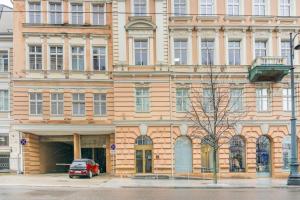 a building with a car parked in front of it at Luxury & Best location in Vilnius