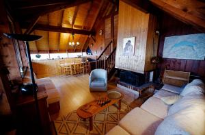 a living room with a couch and a table at chalet haute-savoie in Thollon