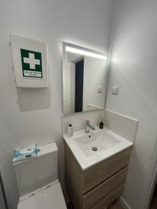 a bathroom with a sink and a toilet and a mirror at Casinha da Portela in Sintra +9 photos