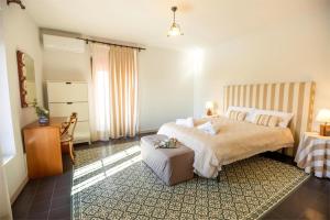 a bedroom with a large bed and a chair at Teralba 1 Casa Rural in La Calzada de Oropesa +102 photos