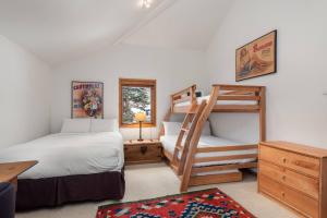 a bedroom with two beds and a bunk bed at Ridge 27 in Snowmass Village +42 photos
