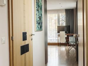 an open door to a living room with a desk at Holiday Beach Budapest Wellness Hotel with Sauna Park in Budapest