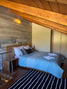 a bedroom with a bed and a wooden ceiling at Frigias 2 in Arachova
