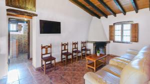 a living room with a couch and a fireplace at Casa Tobalo Hijo Almachar by Ruralidays in Almáchar