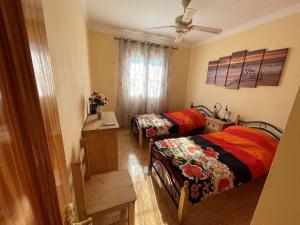 a bedroom with two beds and a window at Llanos del Peral - Zurgena - sleeps 6 - R092 in Zurgena +15 photos