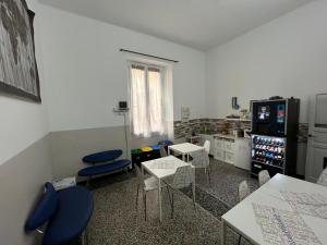 a living room with chairs and tables and a tv at Le stanze della Lanterna in Genoa