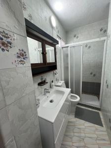 a white bathroom with a sink and a shower at Casa Playa Paraiso Manilva in Manilva