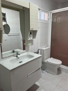 a white bathroom with a sink and a toilet at Casa Playa Paraiso Manilva in Manilva +19 photos