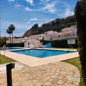 a large swimming pool in front of a building at Casa Playa Paraiso Manilva in Manilva