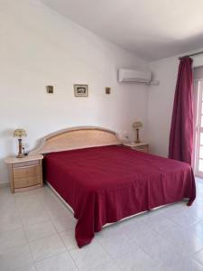 a bedroom with a large bed with a red blanket at Casa Playa Paraiso Manilva in Manilva