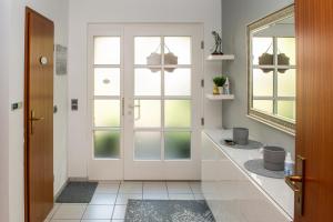 a bathroom with a white door and windows at Ferienhaus Eisenach in Eisenach +45 photos