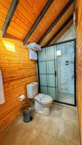 a bathroom with a toilet and a glass shower at Luna Home Club in Samandağı