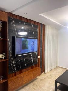 a living room with a flat screen tv on a wall at Appartement de luxe à Casablanca in Aïn Sebaa +7 photos