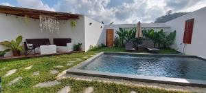 a swimming pool in the backyard of a house at Villa Francine El Nido in El Nido