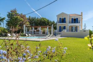 a villa with a swimming pool and a yard at Eglina Celeste Villa in Minia