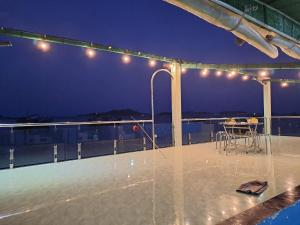a patio with a table on the roof at night at SKY & SEA NAM DU in Nam Du +27 photos