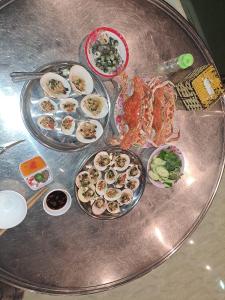 a table with several plates of food on it at SKY & SEA NAM DU in Nam Du