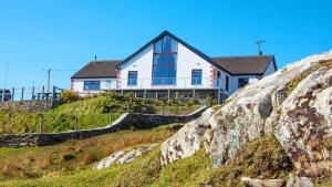 a house sitting on top of a hill at Craggy Cottage 1 in Inishturk