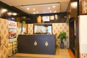 a restaurant with a counter with a potted plant at Malaysia inn in Chennai